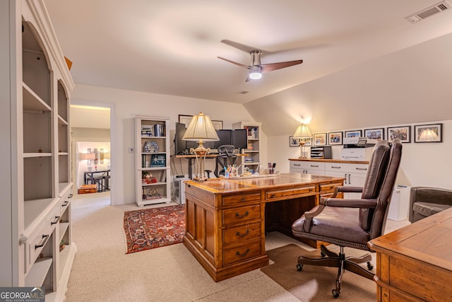 office featuring ceiling fan, lofted ceiling, and light colored carpet