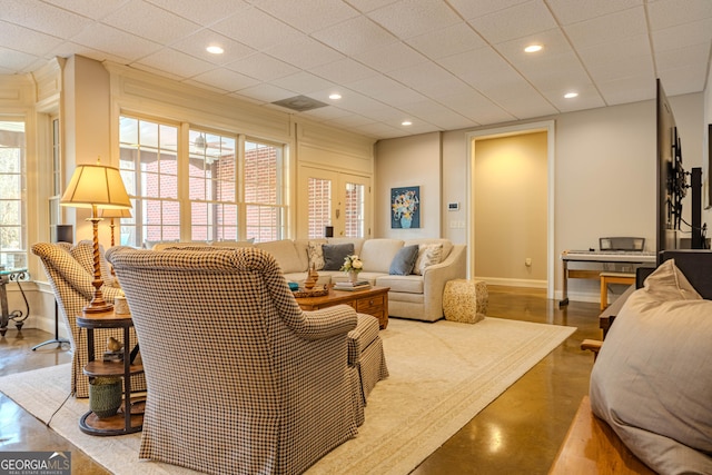 living room featuring a paneled ceiling