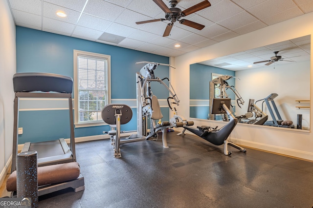 exercise room featuring ceiling fan and a drop ceiling