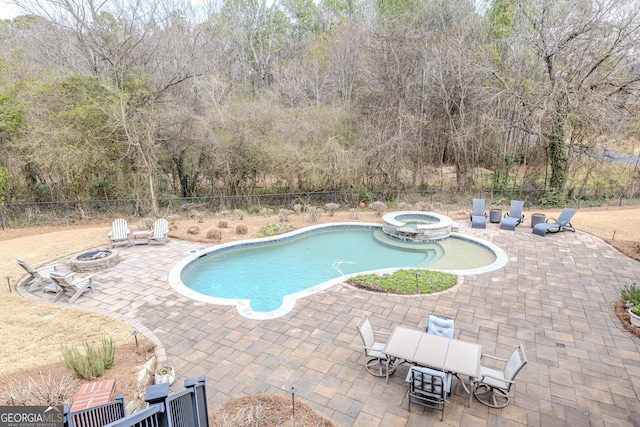 view of pool featuring an in ground hot tub, a patio area, and a fire pit