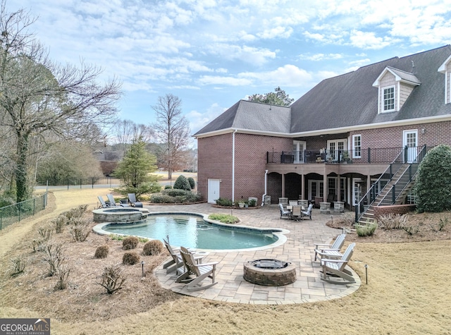 view of swimming pool featuring an outdoor fire pit and a patio