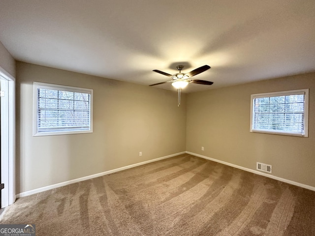 empty room featuring carpet floors and ceiling fan