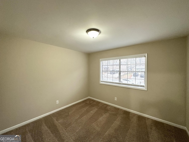 unfurnished room featuring carpet