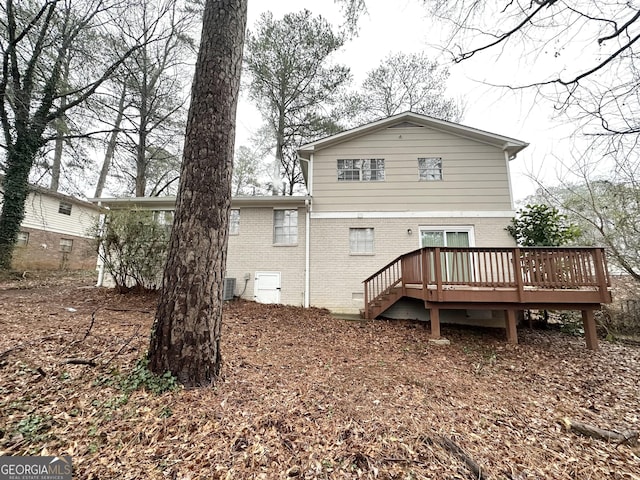 back of house with central AC and a wooden deck