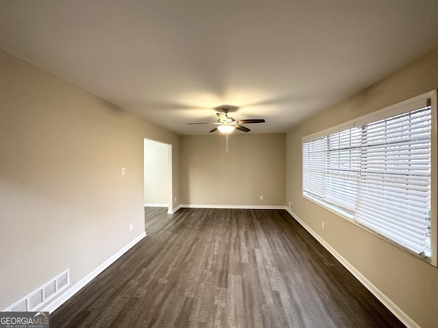 spare room featuring dark hardwood / wood-style floors and ceiling fan