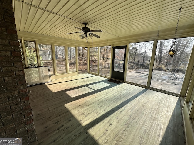 unfurnished sunroom featuring ceiling fan and wooden ceiling