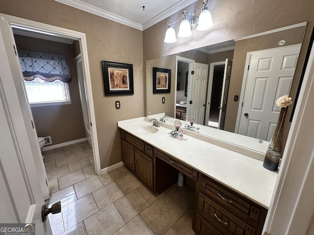 bathroom with ornamental molding, vanity, and a textured ceiling