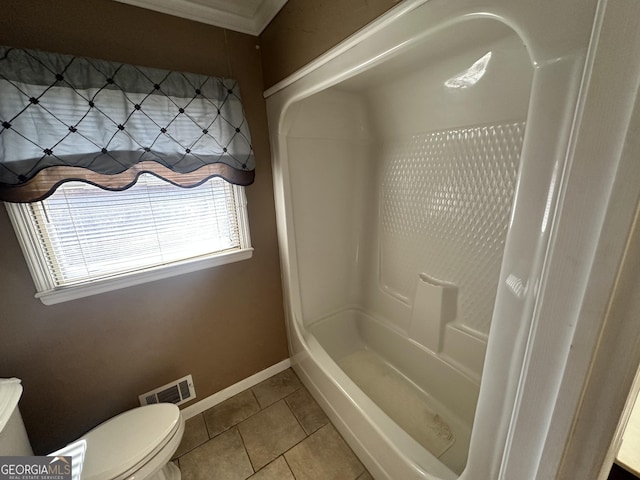 bathroom with toilet, tile patterned floors, and walk in shower