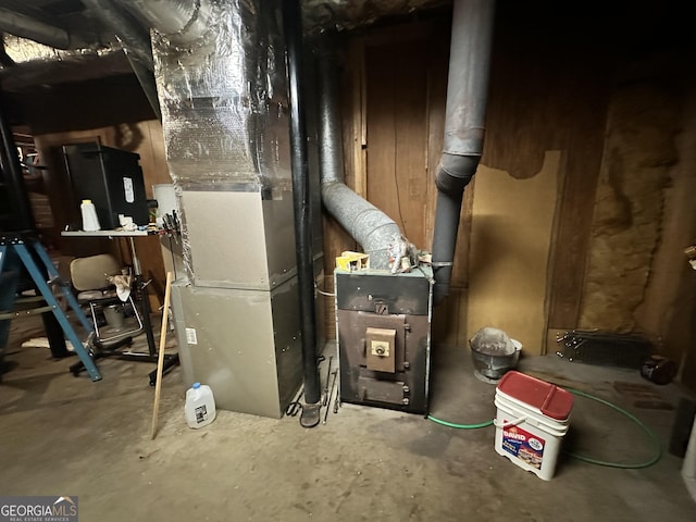 utility room featuring heating unit