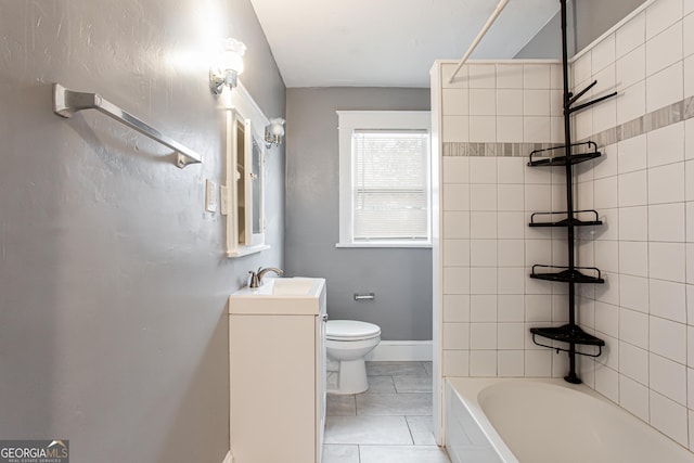 full bathroom featuring vanity, tile patterned flooring, tiled shower / bath combo, and toilet