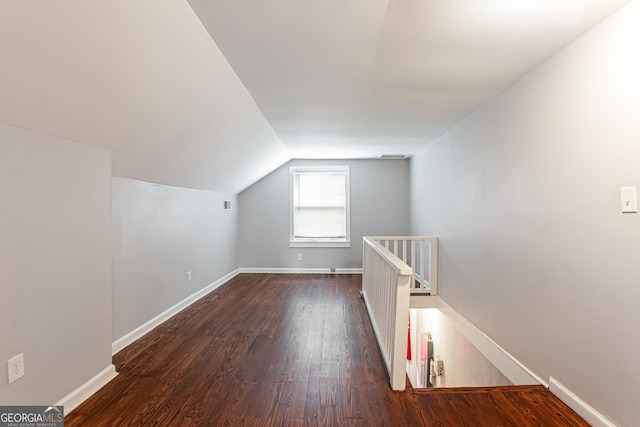 additional living space with lofted ceiling and dark hardwood / wood-style flooring