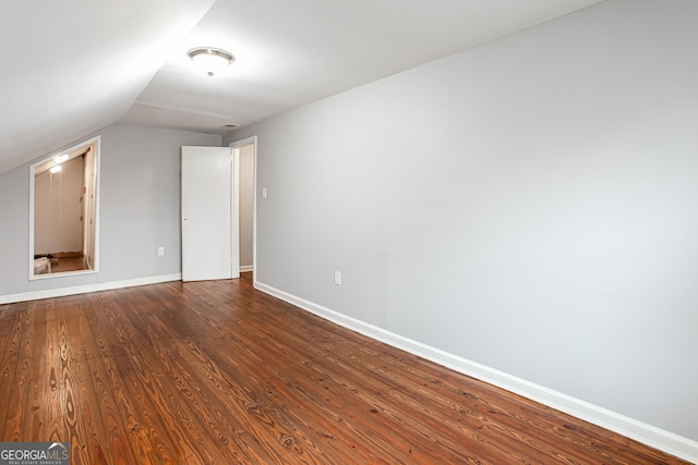 interior space featuring dark hardwood / wood-style floors and vaulted ceiling