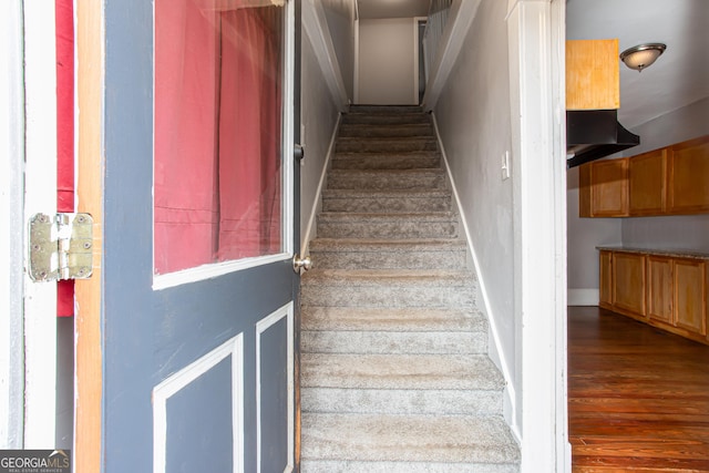 stairs with wood-type flooring