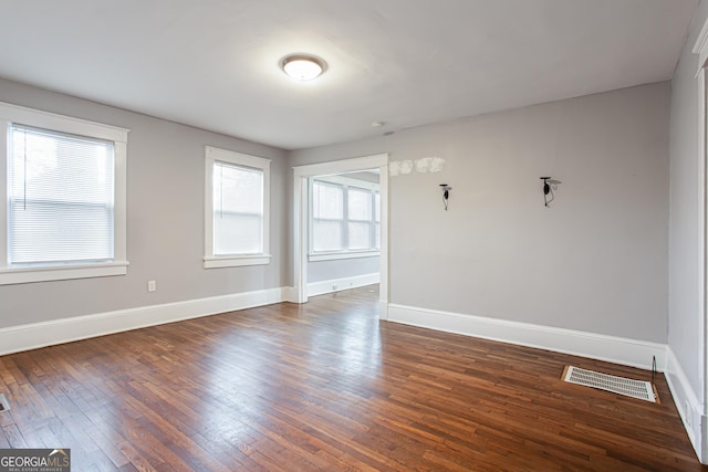 spare room featuring dark hardwood / wood-style floors