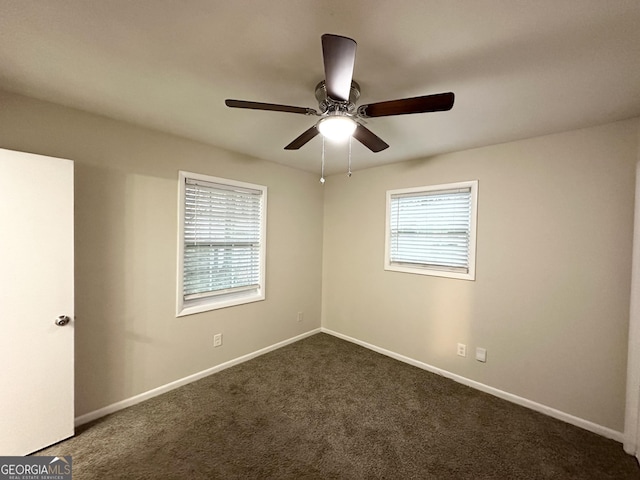 carpeted spare room featuring ceiling fan