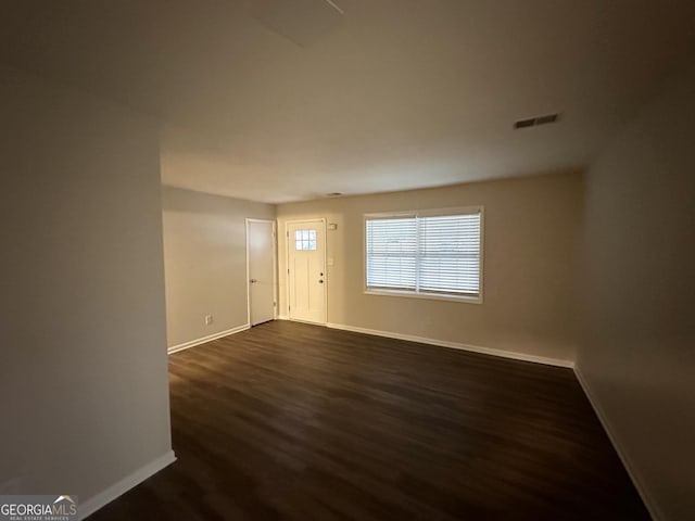 spare room featuring dark hardwood / wood-style flooring