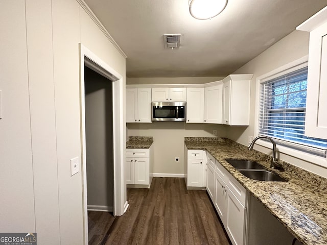 kitchen featuring white cabinetry, dark wood-type flooring, sink, and stone counters