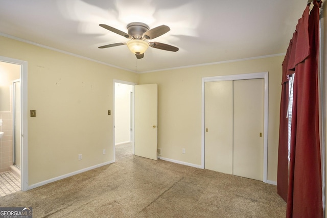 unfurnished bedroom with crown molding, ceiling fan, a closet, and light carpet