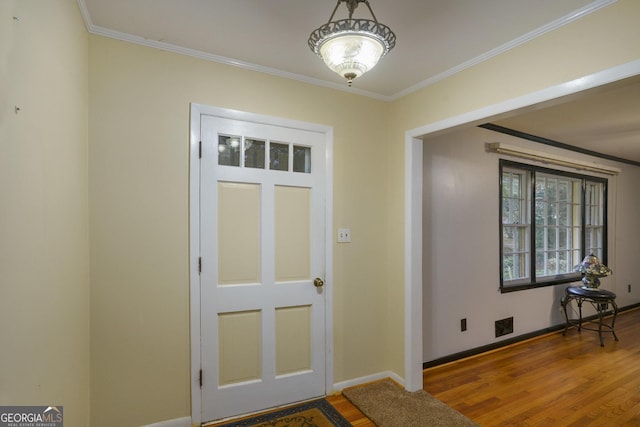 entrance foyer featuring ornamental molding and wood-type flooring