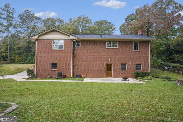 back of property with cooling unit, a patio area, and a lawn