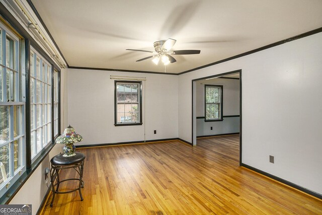 empty room featuring ceiling fan, ornamental molding, and light hardwood / wood-style flooring