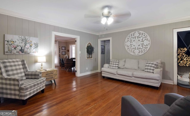 living room featuring crown molding, dark wood-type flooring, and ceiling fan