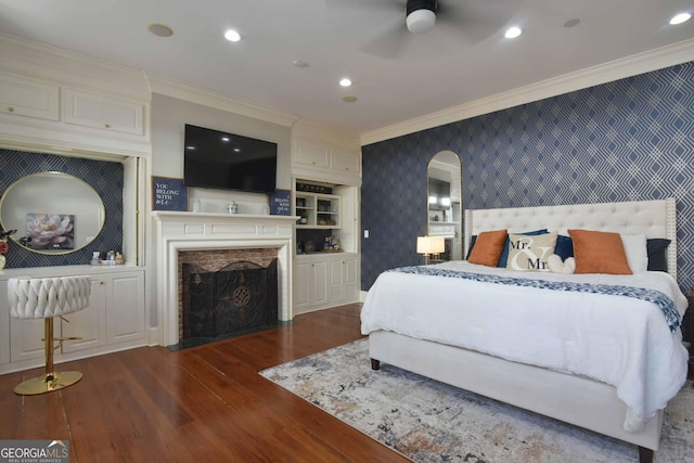 bedroom with crown molding, dark wood-type flooring, and ceiling fan