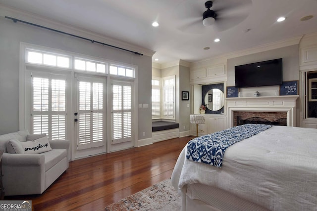 bedroom with crown molding, dark hardwood / wood-style floors, and access to exterior