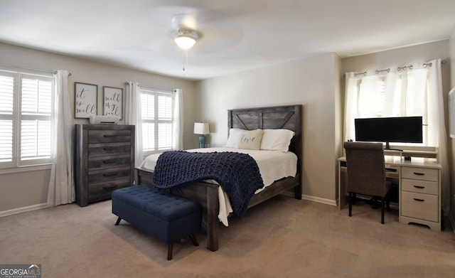 bedroom featuring light colored carpet and ceiling fan