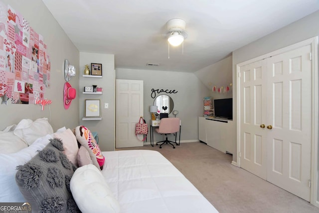 bedroom featuring ceiling fan, a closet, and light carpet