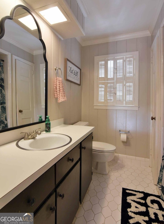 bathroom featuring vanity, crown molding, tile patterned floors, and toilet