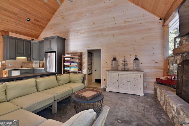 living room featuring high vaulted ceiling, sink, wood ceiling, and wood walls