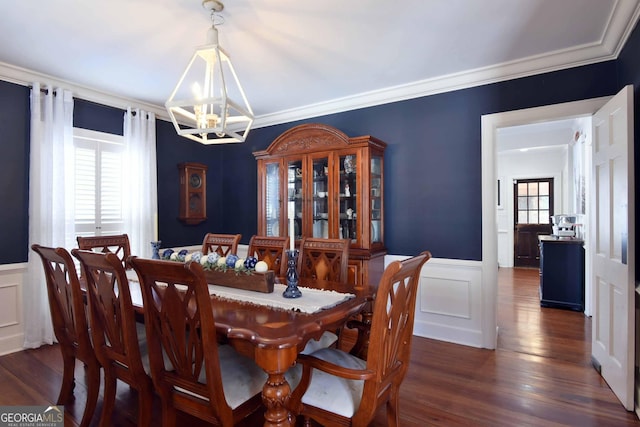 dining room with crown molding, dark hardwood / wood-style floors, and a chandelier