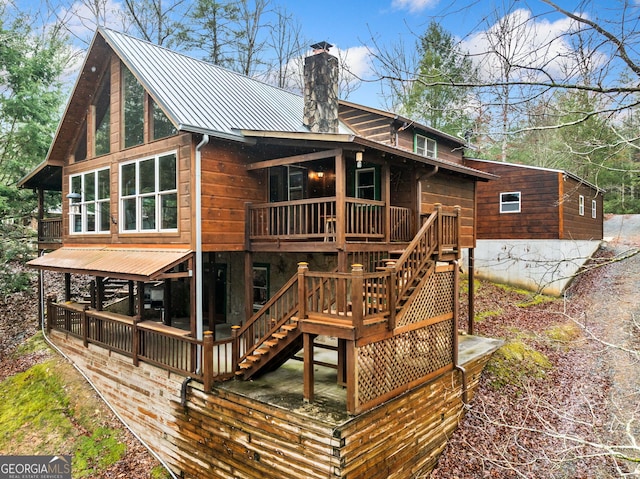 back of house featuring a deck