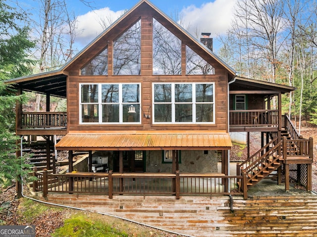 rear view of house featuring a deck