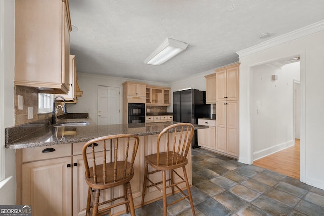 kitchen with sink, crown molding, a breakfast bar, decorative backsplash, and kitchen peninsula