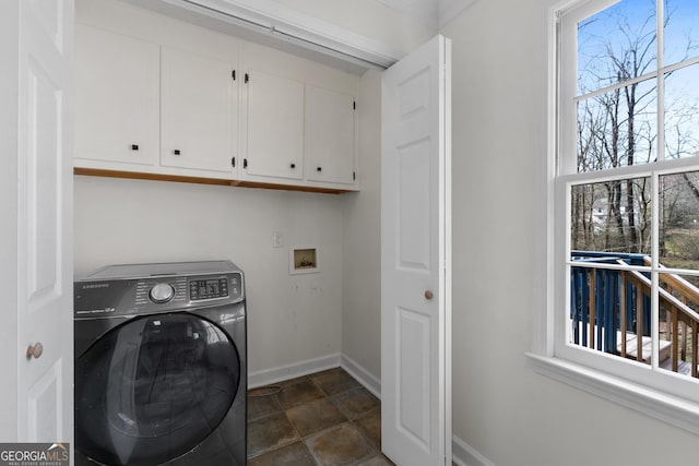 clothes washing area with cabinets and washer / clothes dryer