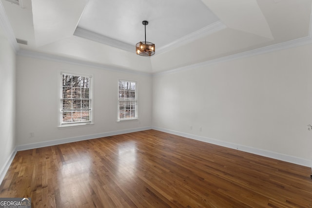 unfurnished room featuring hardwood / wood-style flooring, ornamental molding, and a tray ceiling