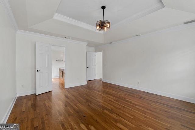 unfurnished bedroom featuring a notable chandelier, dark hardwood / wood-style floors, ornamental molding, and a raised ceiling