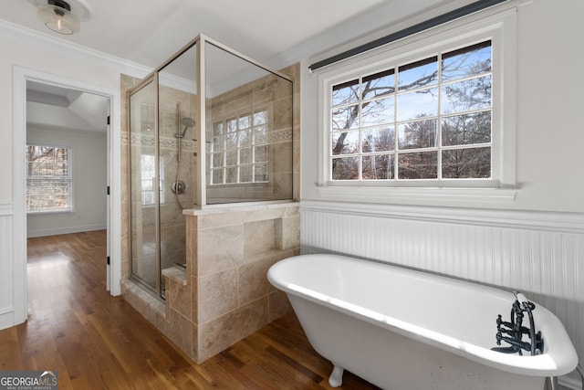 bathroom with hardwood / wood-style floors, crown molding, and plus walk in shower