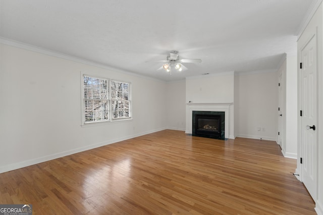 unfurnished living room with crown molding, ceiling fan, and light hardwood / wood-style flooring