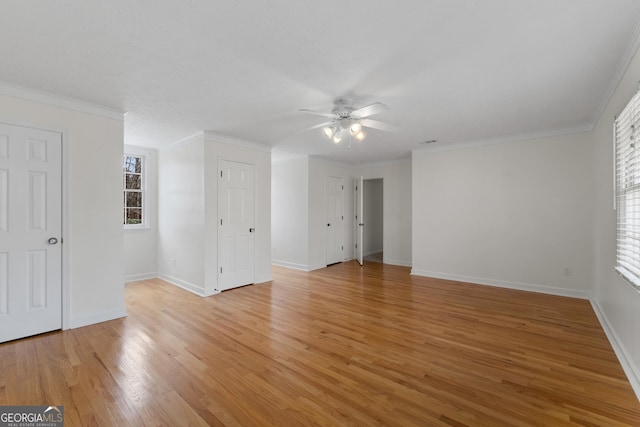 interior space with ceiling fan, ornamental molding, and hardwood / wood-style floors