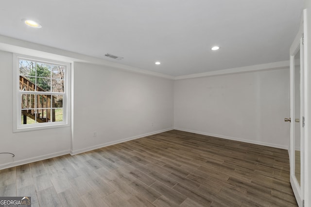 spare room with wood-type flooring