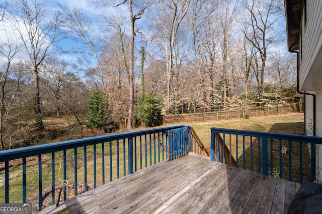 wooden terrace featuring a lawn