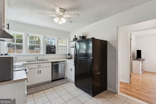 kitchen featuring sink, white cabinetry, black refrigerator, dishwasher, and ceiling fan