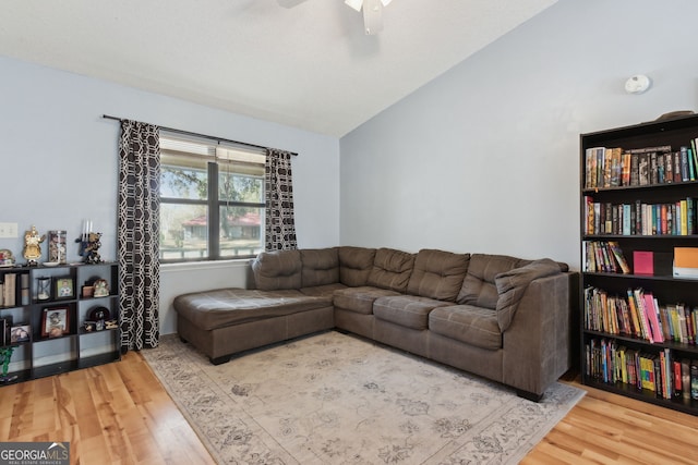 living room with lofted ceiling, wood-type flooring, and ceiling fan