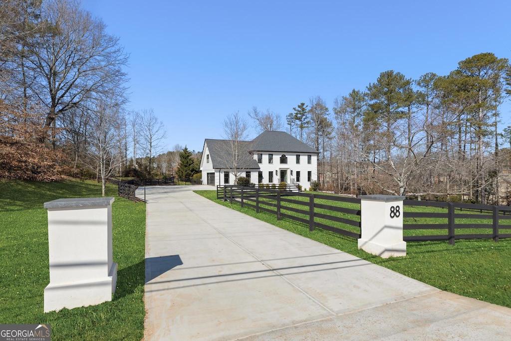 french country inspired facade featuring a front lawn