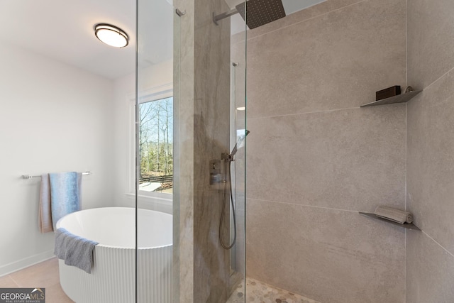 bathroom with tile patterned floors and separate shower and tub