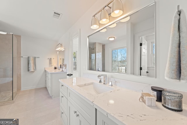 bathroom with walk in shower, tile patterned floors, and vanity