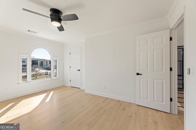 unfurnished room with ornamental molding, ceiling fan, and light wood-type flooring